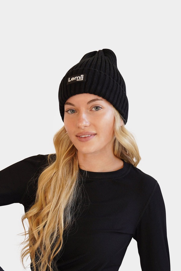 Lemii Label - Woman wearing a black hat and  outfit with a logo on a white background