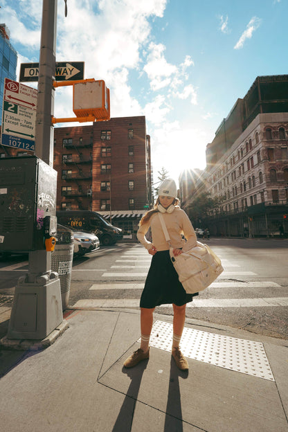 Lemii Label - Girl standing on the street - crew sweater - tennis skirt- hat